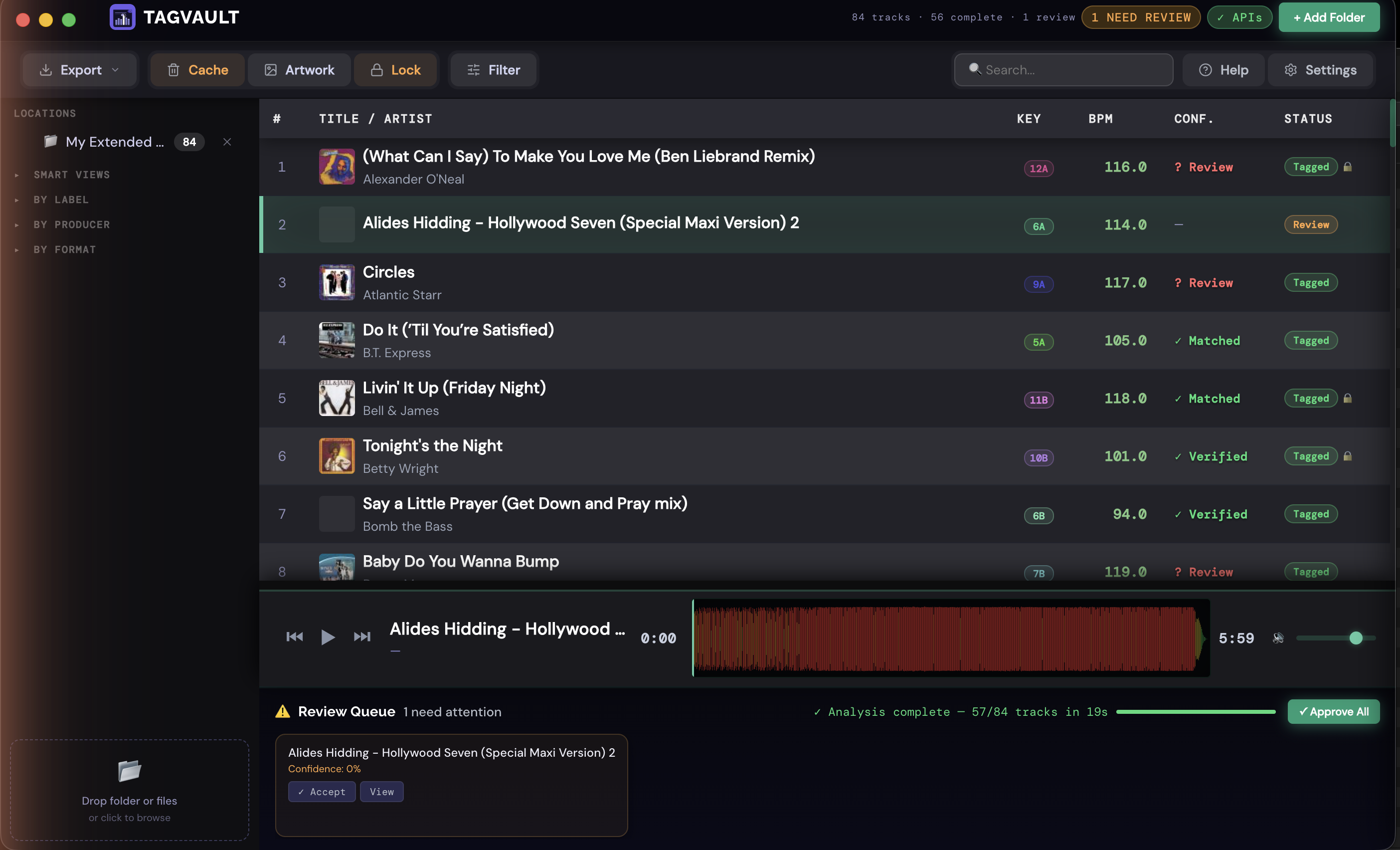 TagVault library loaded with 84 tracks, sidebar location, and Review Queue banner